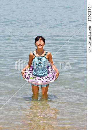 A girl who enjoys swimming A girl who enjoys swimming 56925304