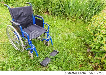Empty wheelchair standing on grass in hospital Empty wheelchair standing on grass in hospital 56925755