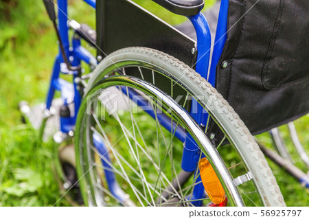 Empty wheelchair standing on grass in hospital 56925797