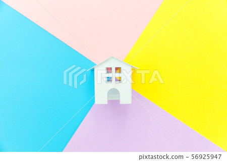 Miniature white toy house isolated on blue yellow 56925947