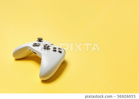 White joystick on yellow background. Computer 56926055