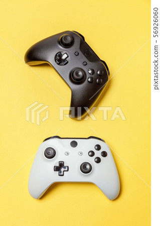 White and black two joystick on yellow background. White and black two joystick on yellow background. 56926060