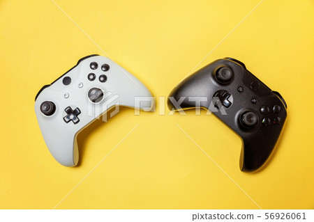 White and black two joystick on yellow background. White and black two joystick on yellow background. 56926061