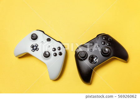 White and black two joystick on yellow background. White and black two joystick on yellow background. 56926062