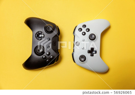 White and black two joystick on yellow background. 56926065