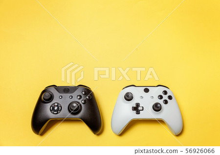 White and black two joystick on yellow background. White and black two joystick on yellow background. 56926066