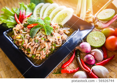 Spicy minced pork salad Thai food served on table 56926744