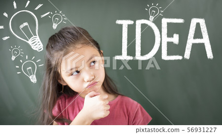 little girl standing against chalkboard and idea 56931227