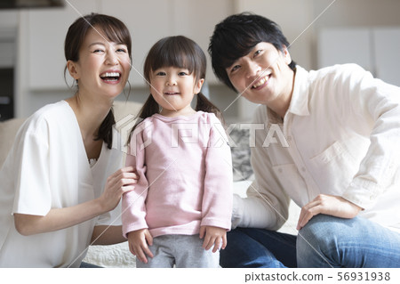 A family relaxing in the living room 56931938