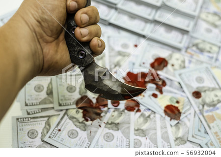 karambit knife on stack bundles of 100 US dollars banknotes bloody 56932004