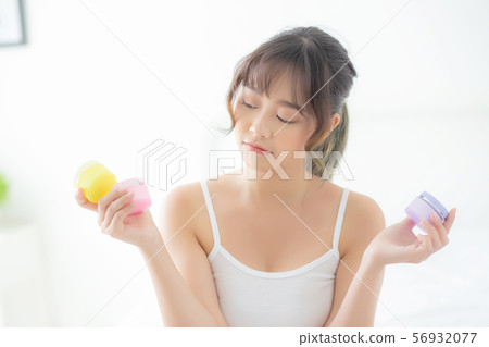 Beautiful portrait young asian woman holding cream 56932077