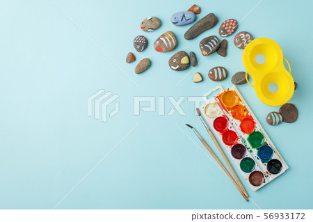 Hand-painted colorful stones and watercolor paint 56933172