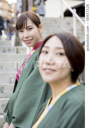 A woman in a yukata climbing the stone steps of Ikaho Onsen A woman in a yukata climbing the stone steps of Ikaho Onsen 56937326