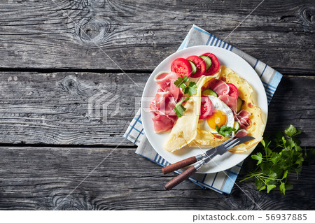 Crepes with fillings of fried egg, ham Crepes with fillings of fried egg, ham 56937885