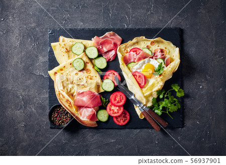 breakfast of Crepes with fried egg fillings 56937901