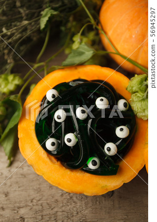 green and black multicolored gummy worms and candies eyes with pumpkin green and black multicolored gummy worms and candies eyes with pumpkin 56945297
