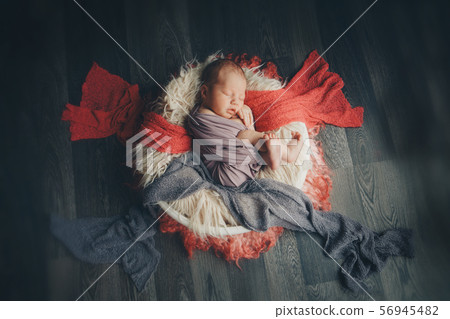 newborn baby wrapped in a blanket sleeping in a basket. concept of childhood, healthcare, IVF 56945482