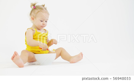 Little baby girl eats her oatmeal with fruit 56948033