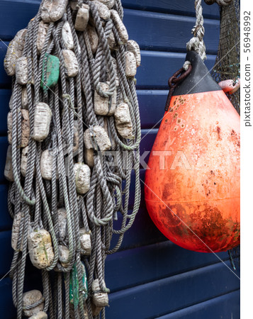 Fishing nets and ropes hang outside on the house 56948992