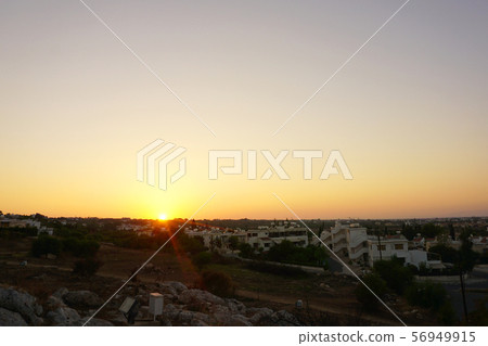 beautiful summer sunset in the valley overlooking small houses 56949915