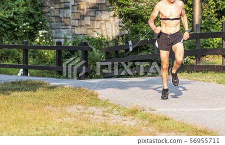 Shirtless runner wearing heart rate monitor on Shirtless runner wearing heart rate monitor on 56955711