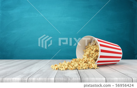 3d rendering of popcorn bucket lying sidelong with some popcorn spilled on wooden surface near blue 56956424