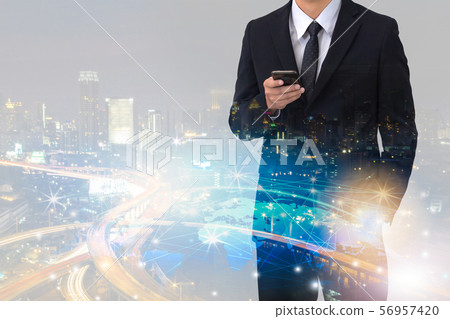 Double exposure of businessman with cityscape 56957420