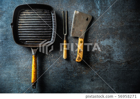 Vintage grill pan butcher and fork on dark 56958271