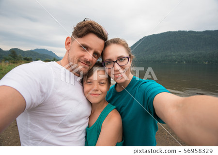 Selfie of family on the Teletskoye lake Selfie of family on the Teletskoye lake 56958329