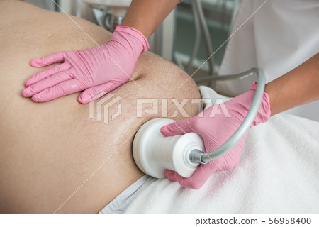 Belly cavitation at modern beauty clinic 56958400