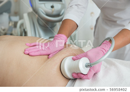 Belly cavitation at modern beauty clinic Belly cavitation at modern beauty clinic 56958402