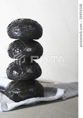 Black bread buns stacked. Hamburger bread loaves 56959288