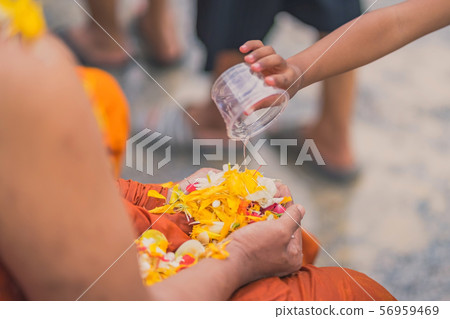 People pouring water to Buddhist Monk and gives blessing in Thailand Songkran annual festival People pouring water to Buddhist Monk and gives blessing in Thailand Songkran annual festival 56959469