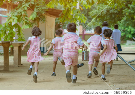 Back view of Kindergarten students run back to the classroom after having lunch. 56959596