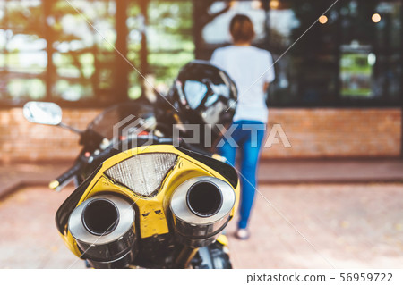 A sporty motorcycle parked in front of a coffee shop A sporty motorcycle parked in front of a coffee shop 56959722