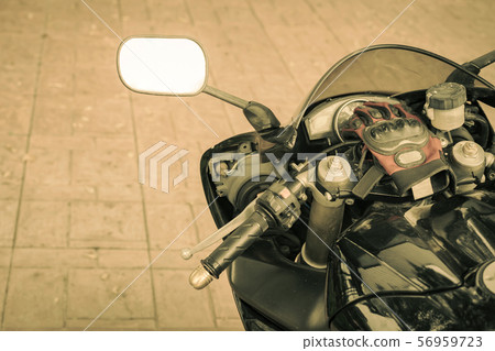 A sporty motorcycle parked in front of a coffee shop 56959723