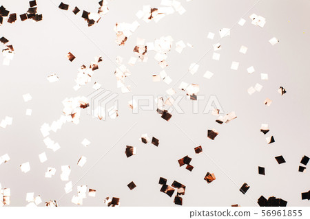 Falling silver confetti on grey backdrop. 56961855