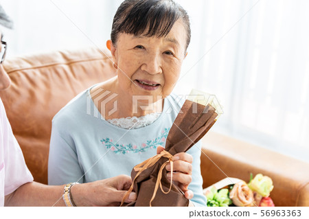 Senior woman happy with present Senior woman happy with present 56963363