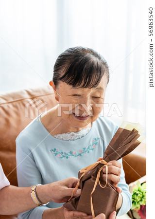 Senior woman happy with present 56963540