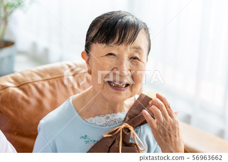 Senior woman happy with present Senior woman happy with present 56963662