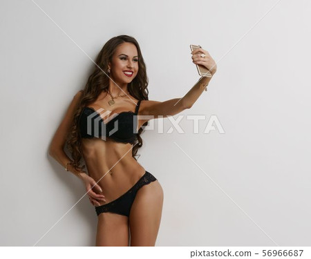 Girl, black lingerie standing in flirtatious pose Girl, black lingerie standing in flirtatious pose 56966687