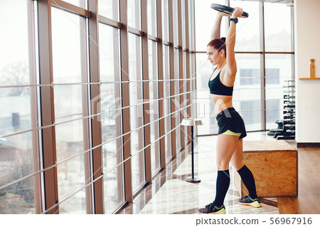 A beautiful girl is engaged in a gym A beautiful girl is engaged in a gym 56967916