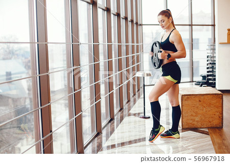 A beautiful girl is engaged in a gym A beautiful girl is engaged in a gym 56967918