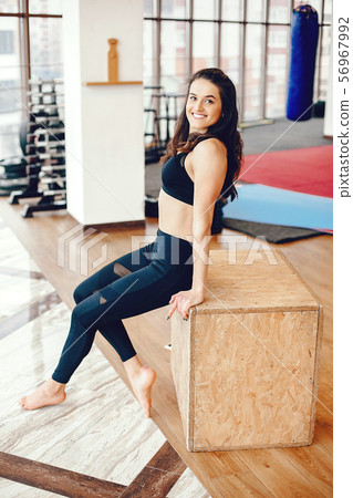 A beautiful girl is engaged in a gym A beautiful girl is engaged in a gym 56967992