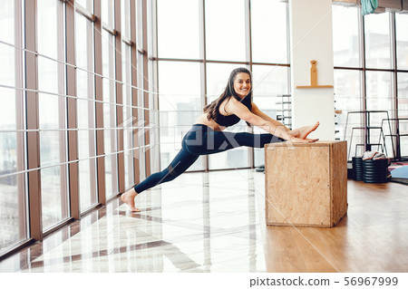 A beautiful girl is engaged in a gym A beautiful girl is engaged in a gym 56967999