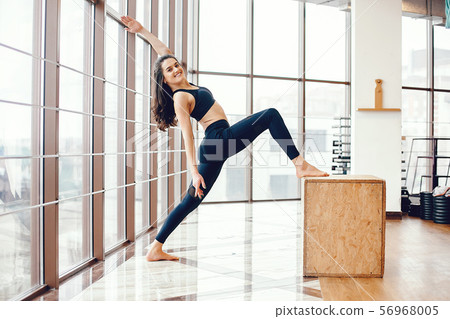 A beautiful girl is engaged in a gym A beautiful girl is engaged in a gym 56968005