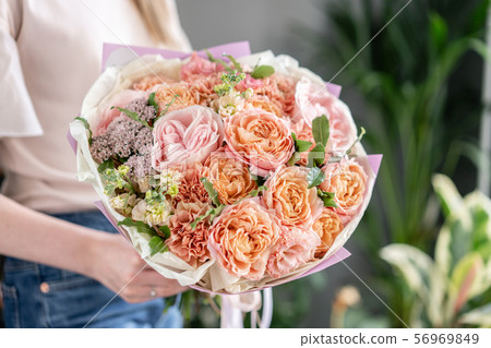 Beautiful bouquet of mixed flowers in woman hand. Floral shop concept . Handsome fresh bouquet 56969849
