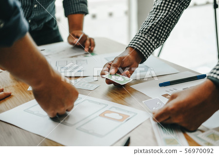user experience UX designer designing web on smart phone layout. UI developer planning working on mobile application prototype user experience UX designer designing web on smart phone layout. UI developer planning working on mobile application prototype 56970092