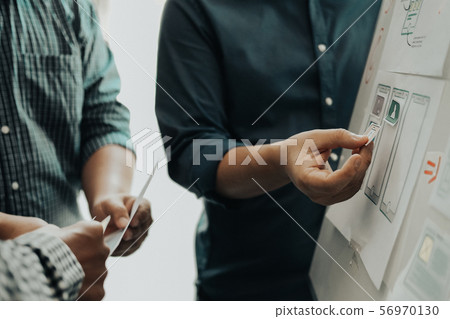 user experience UX designer designing web on smart phone layout. UI developer planning working on mobile application prototype user experience UX designer designing web on smart phone layout. UI developer planning working on mobile application prototype 56970130