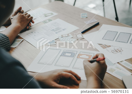 user experience UX designer designing web on smart phone layout. UI developer planning working on mobile application prototype user experience UX designer designing web on smart phone layout. UI developer planning working on mobile application prototype 56970131